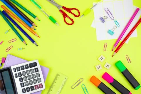 A vibrant array of colorful school supplies arranged neatly on a bright yel.. Stock Photos