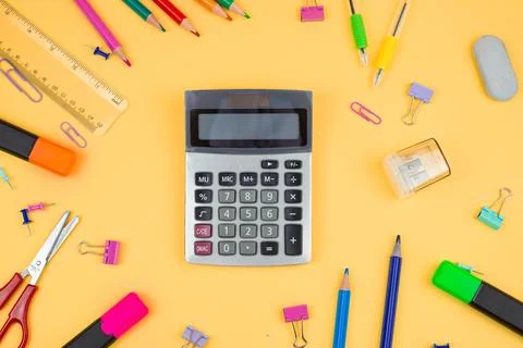 A Vibrant Array of Colorful Study Supplies Including a Calculator on a Brig.. Stock Photos