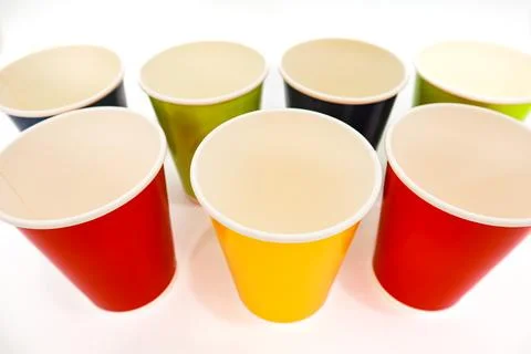 Vibrant Array of Disposable Paper Cups in Assorted Colors on White Background Stock Photos