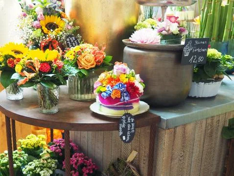 Vibrant array of flowers in a variety of colors artfully arranged on a table out Foto stock