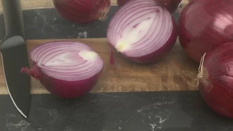 A vibrant array of Fresh Red Onions laid out beautifully on a rustic Wooden Stock Footage 287117553