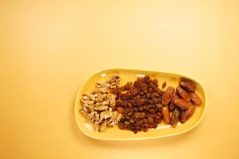 A vibrant assortment of assorted nuts and dried fruits beautifully displayed on Stock Photos