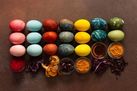 A vibrant assortment of Easter eggs rests on a surface, beautifully dyed in.. Stock Photos