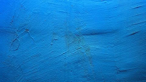 Vibrant azure plaster wall texture featuring subtle brush marks and weather.. Stock Photos