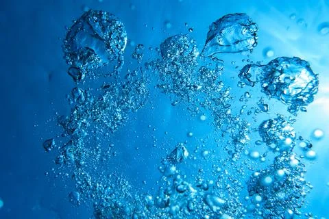 Vibrant azure water with bubbles Stock Photos