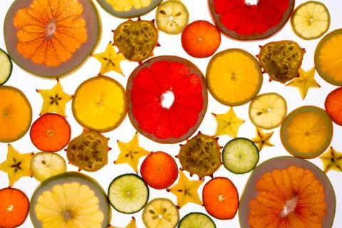 Vibrant backdrop of translucent sliced fresh fruit Stock Photos