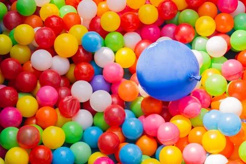 A vibrant background array of balloons illuminates the image with a Foto stock