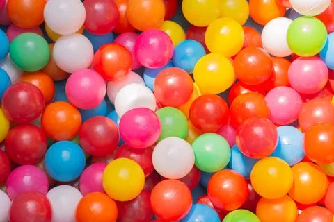 A vibrant background array of balloons illuminates the image with a Foto stock