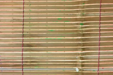 Vibrant bamboo blinds with red thread details Stock Photos
