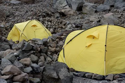 Vibrant Base Camp: A colorful array of tents sprawls across the rocky terra.. 写真素材