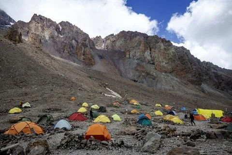 Vibrant Base Camp: A colorful array of tents sprawls across the rocky terra.. Stock Photos