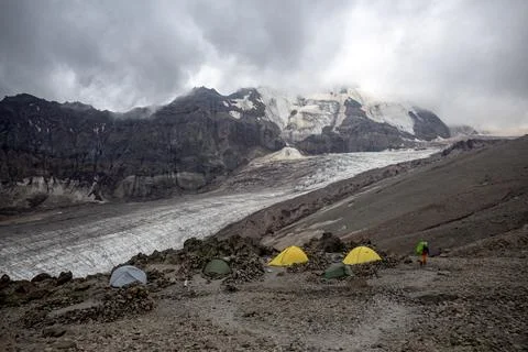 Vibrant Base Camp: A colorful array of tents sprawls across the rocky terra.. Stock Photos