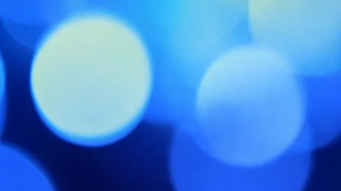 A vibrant blue bokeh background with soft glowing circles. Stock Footage 309997760