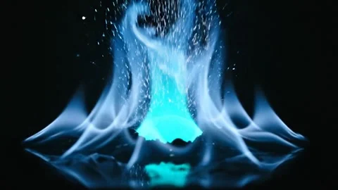Vibrant Blue Flame Erupting with Sparkling Energy Against a Black Background Stock Footage 324072248