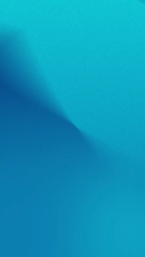 Vibrant blue gradient with subtle grain texture in a seamless loop background. 動画素材 309701240