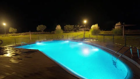 Vibrant Blue Heated Pool Steaming at Night 库存影片 335053910