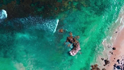 Vibrant Blue Ocean Waves Crashing Against Coastal Rock Stock Footage 339090798