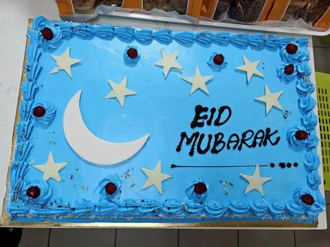 Vibrant blue rectangular cake adorned with The text "EID MUBARAK" Stock Photos