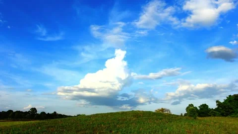 Vibrant Blue Sky with Cumulus Clouds over Silhouetted Landscape Video stock 310921798