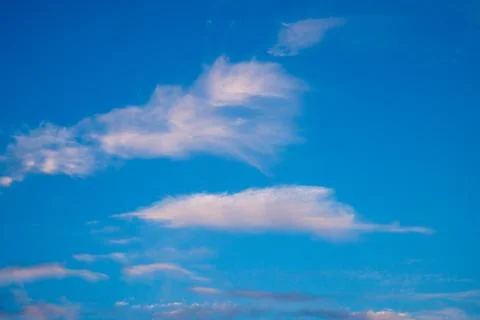 Vibrant blue sky with light clouds Stock Photos