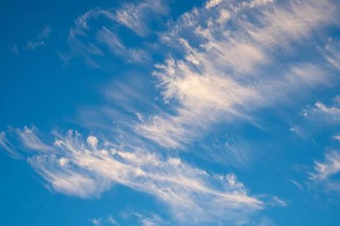 Vibrant blue sky with light clouds Stock Photos