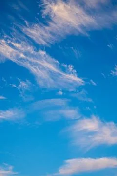 Vibrant blue sky with light clouds Stock Photos