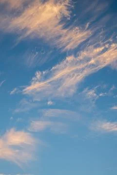Vibrant blue sky with light clouds Stock Photos