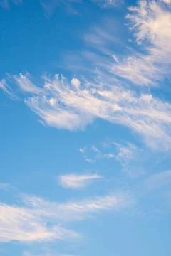 Vibrant blue sky with light clouds Stock Photos