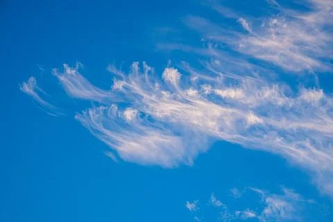Vibrant blue sky with light clouds Stock Photos