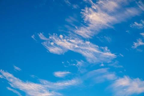 Vibrant blue sky with light clouds Stock Photos