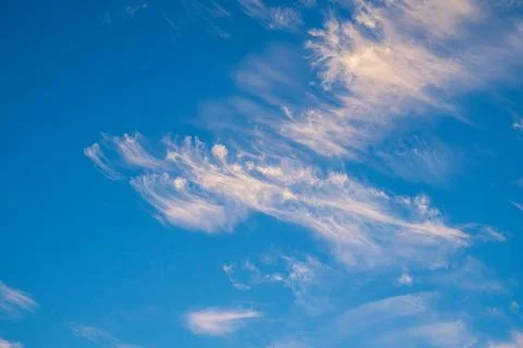 Vibrant blue sky with light clouds Stock Photos