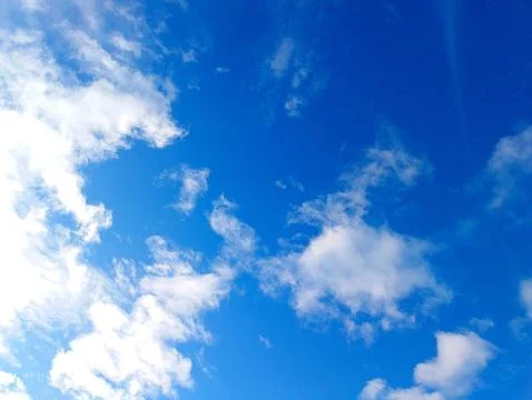 Vibrant Blue Sky with White Clouds Stock Photos