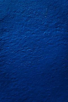 Vibrant blue wall texture: A captivating textured surface in striking blue,.. Stock Photos