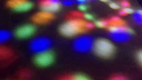 Vibrant Bokeh Light Reflections on a Dark Textured Floor Surface Stock Photos