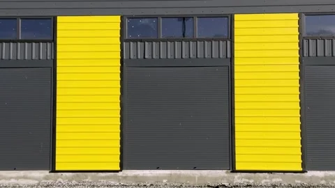 Vibrant Bright Yellow Panels Set Against a Dark Building in Urban Architecture Stock Footage 306062497