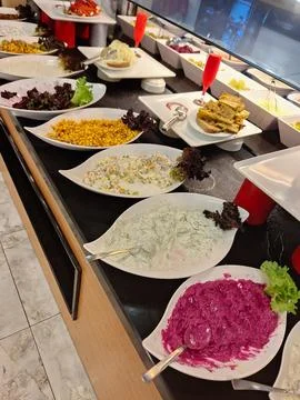 A vibrant buffet display showcases an array of salads and appetizers arranged Foto stock