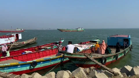 Vibrant bustling Padma river passenger trawler boats docked on the coast Stock Footage 346076587