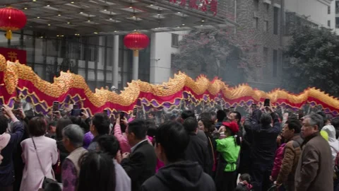 Vibrant Chinese dragon dance during a festive folk parade celebration Stock Footage 302422199