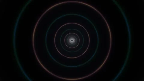 Vibrant circles moving in a spiral pattern on a dark Stock Footage 338004372