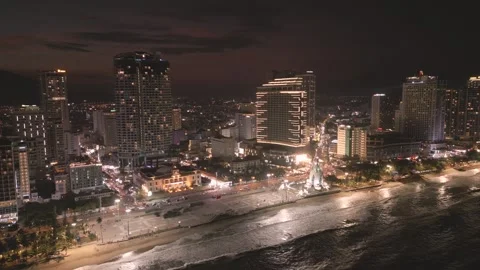 Vibrant cityscape night showcasing bustling streets illuminated buildings along Stock Footage 297929443