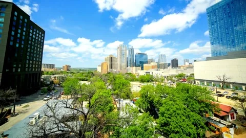 A vibrant cityscape view with blue sky and fluffy white clouds Stock-Footage 312677406