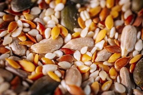 A vibrant close-up of a seed mix featuring pumpkin seeds, flaxseeds Stock Photos