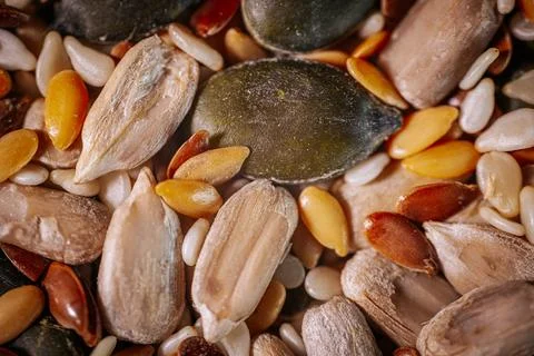A vibrant close-up of a seed mix featuring pumpkin seeds, flaxseeds Stock Photos