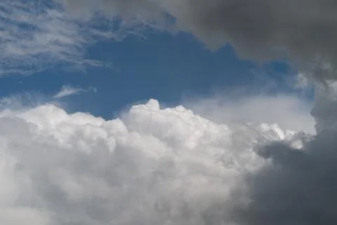 Vibrant clouds in clear sky. Sunlit clouds contrasting with open blue sky. .. Stock Photos