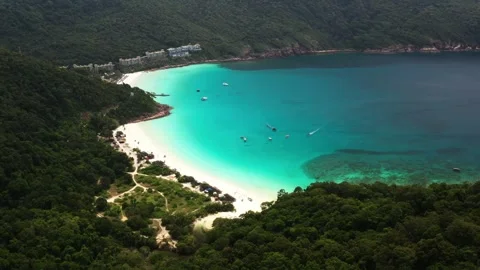 Vibrant coastal view of turtle beach on Redang Island, surrounded by lush green Stock Footage 319653307