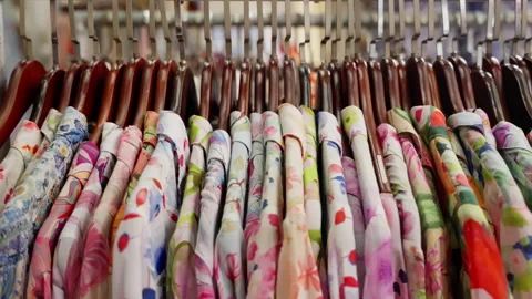 Vibrant Collection of Floral Patterns on Display: A Colorful Array of Shirts Stock Footage 310155847