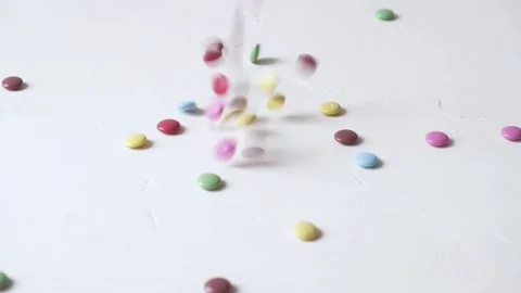 Vibrant colored candy falling down on a white background. Stock Footage 147950978