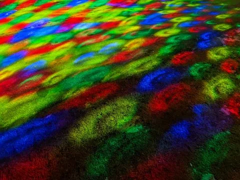 Vibrant Colorful Geometric Light Patterns Projected on a Winter Grass Field Fotos Stock
