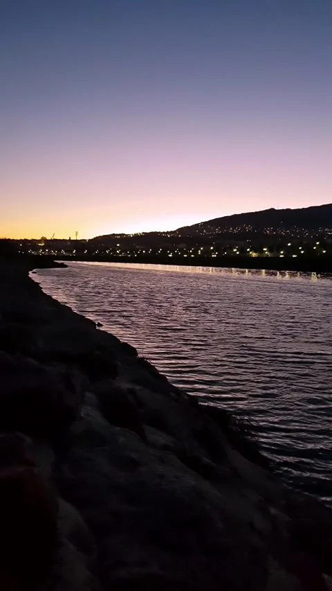 Vibrant colors are reflected in the valley below the city after sun disappears Stock Footage 279933335