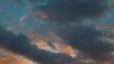 Vibrant colors fill the sky as the sun sets, creating a display of orange, blue, Video stock 339024313